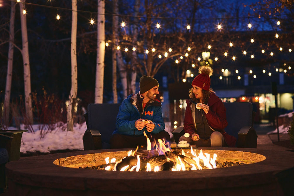 Couple eats smores at firepit at The Lodge at Vail