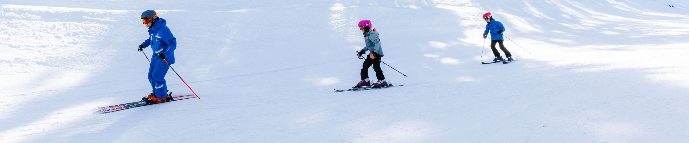Older children skiing with an instructor