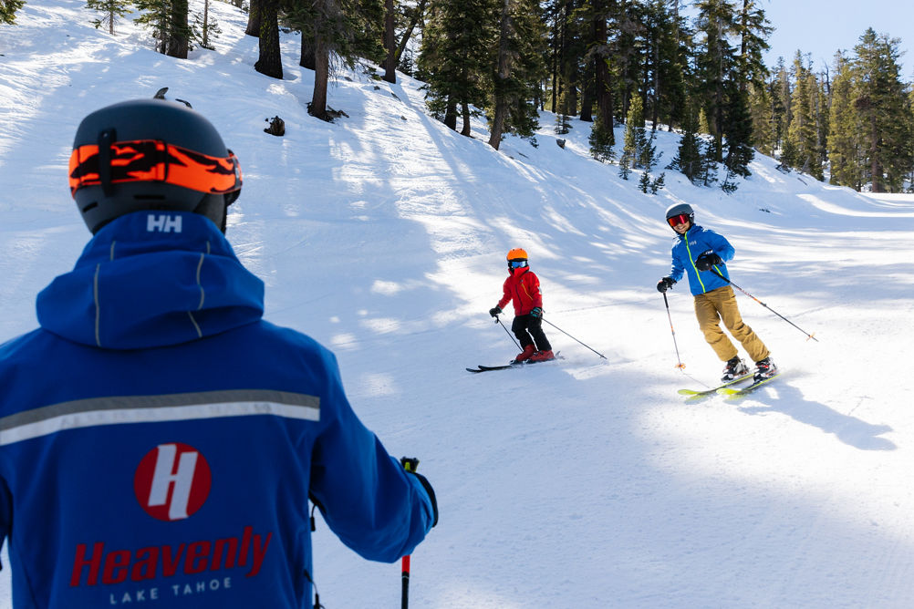 Older children skiing with an instructor