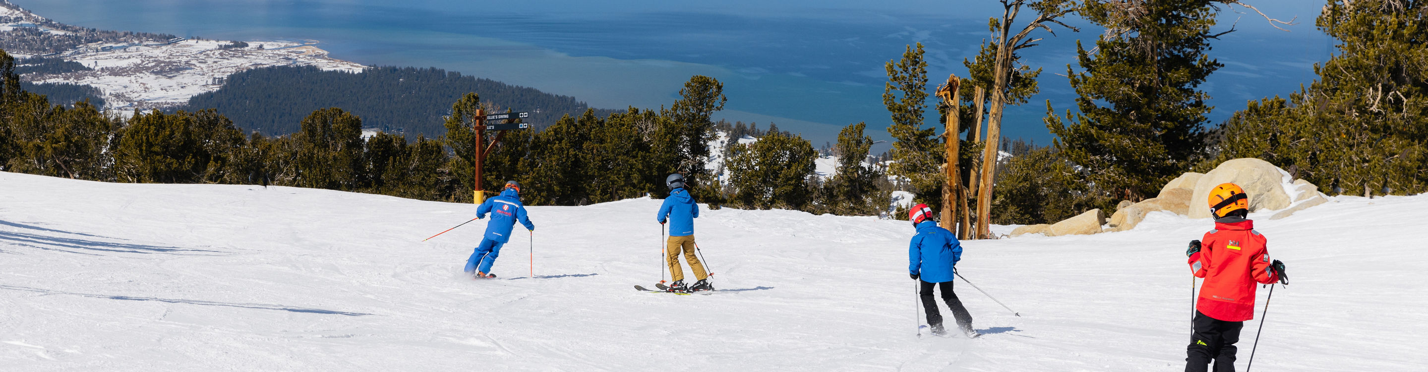 Older children skiing with an instructor