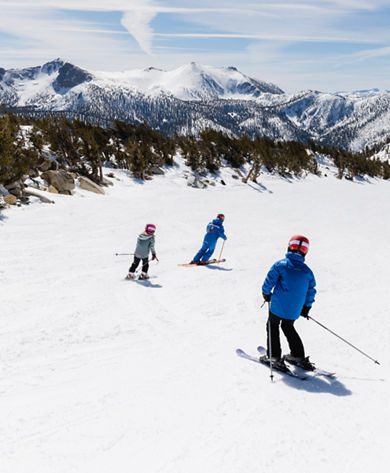 Older children skiing with an instructor