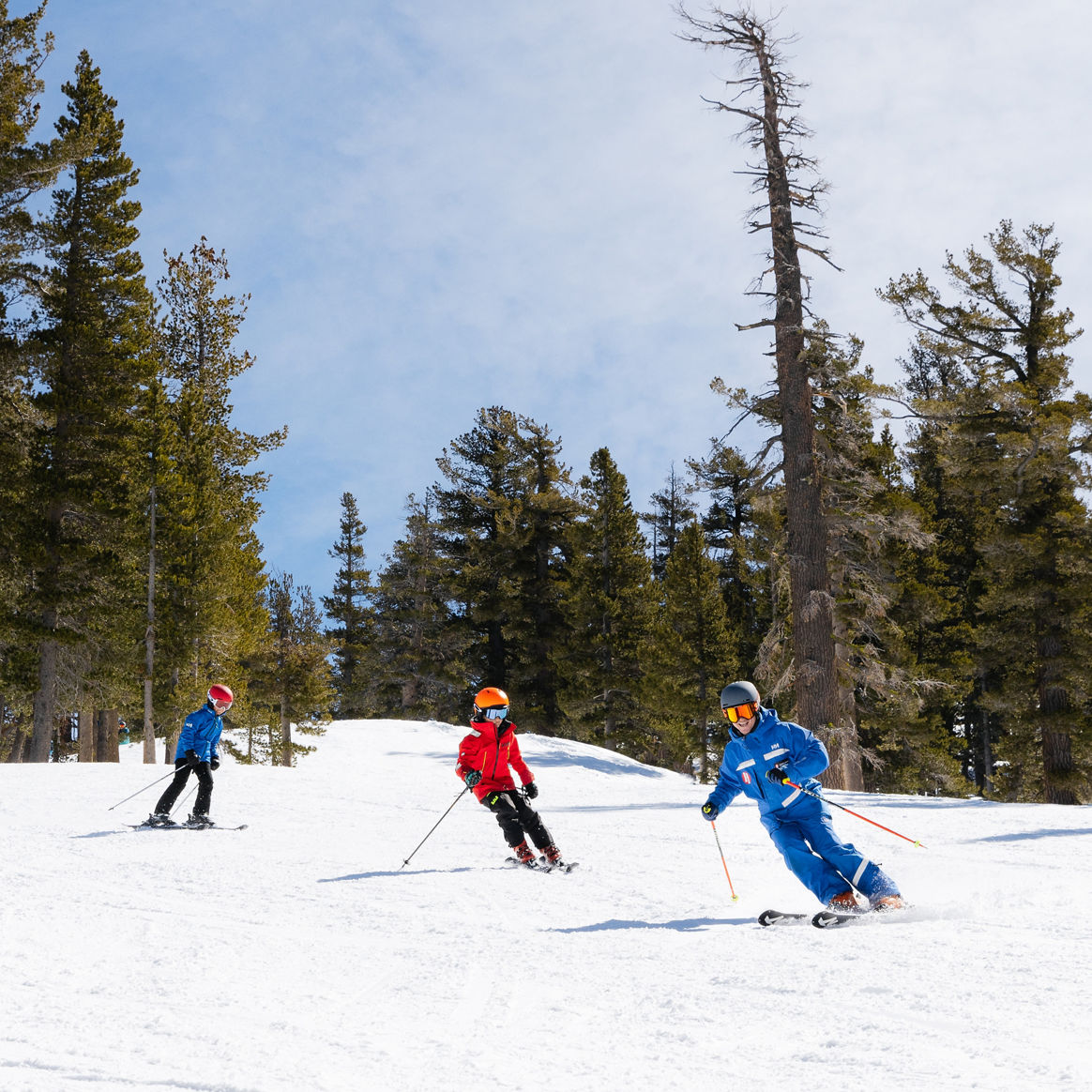 Older children skiing with an instructor