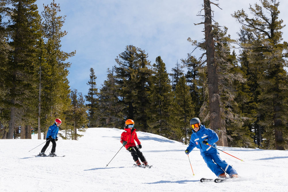Older children skiing with an instructor
