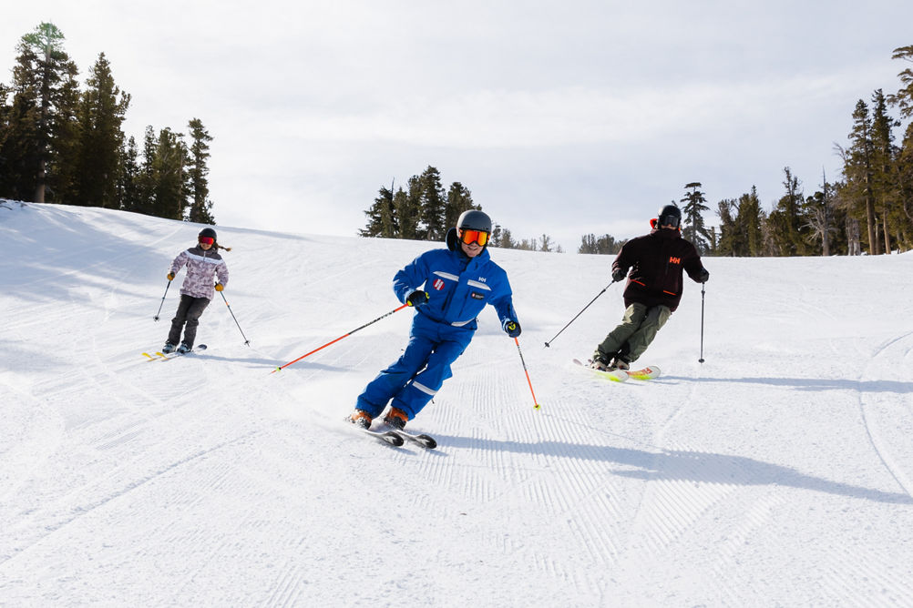 Adults skiing with an instructor