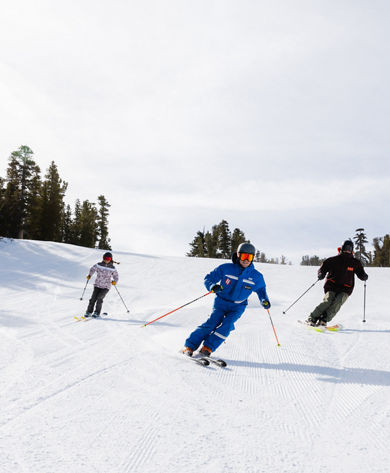 Adults skiing with an instructor