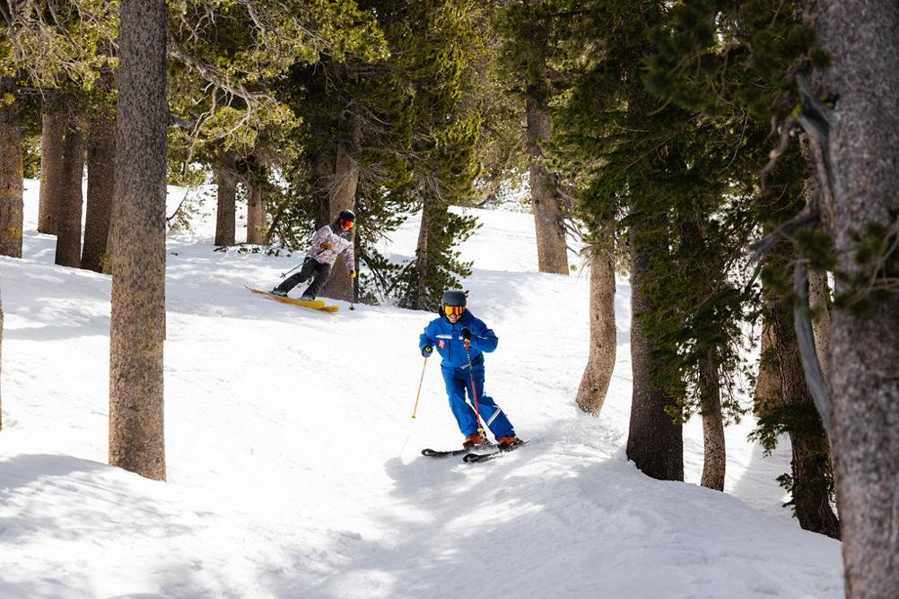 Adults skiing with an instructor