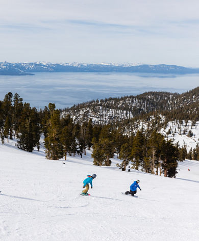 Adults snowboarding with an instructor