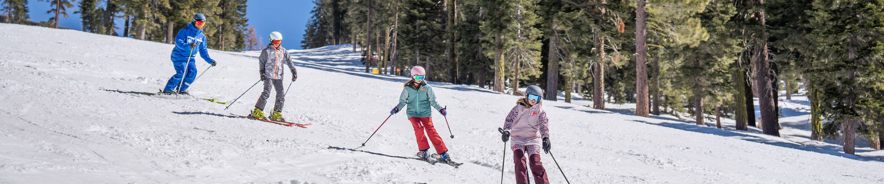 Older children skiing with an instructor