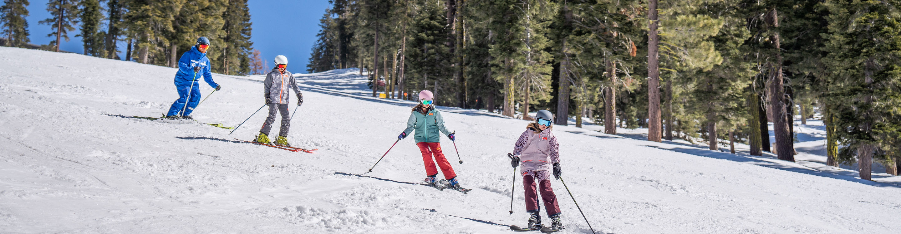Older children skiing with an instructor