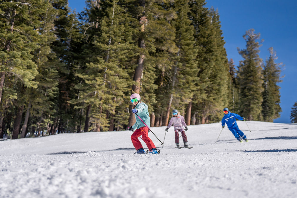 Older children skiing with an instructor