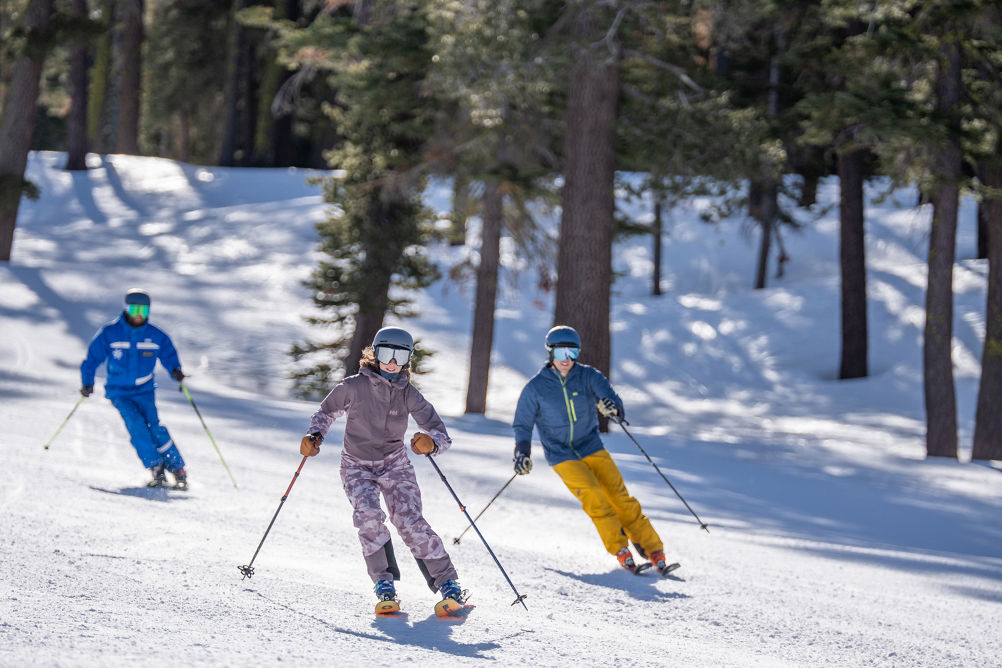 Adults skiing with an instructor