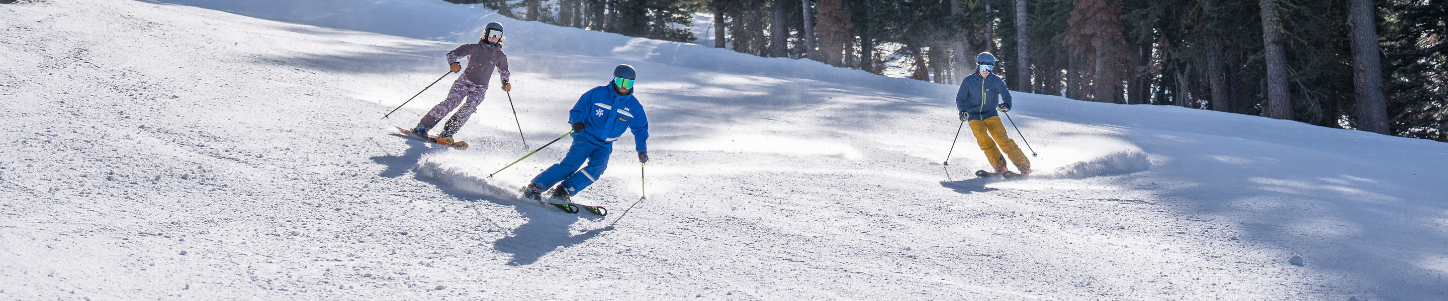 Adults skiing with an instructor
