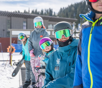 Family snowboarding with an instructor in a private lesson