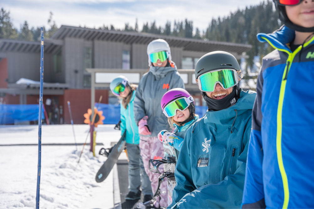 Family snowboarding with an instructor in a private lesson