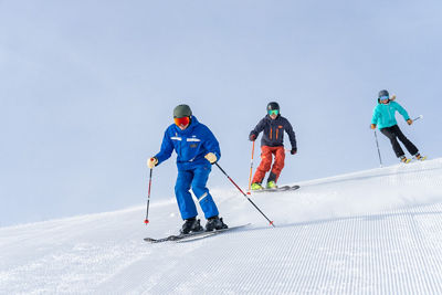 Adults skiing with an instructor
