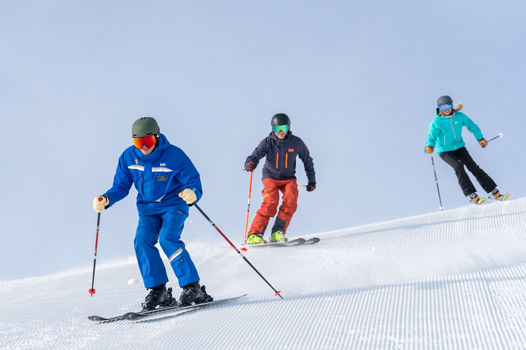 Adults skiing with an instructor