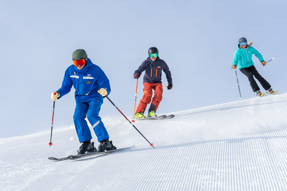 Adults skiing with an instructor