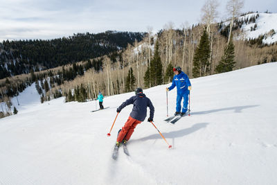 Adults skiing with an instructor