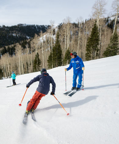 Adults skiing with an instructor