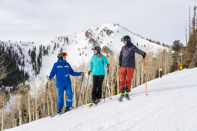 Adults skiing with an instructor