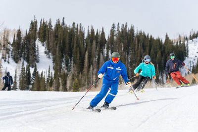 Adults skiing with an instructor