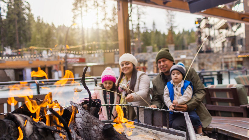 Family has fun around firepits in the Village at Northstar