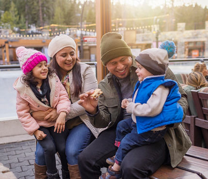 Family has fun around firepits in the Village at Northstar
