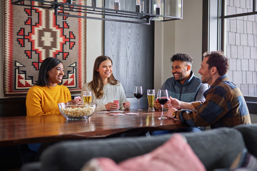 Friends Enjoying Food and Drinks in Room at One Ski Hill at Breckenridge Resort