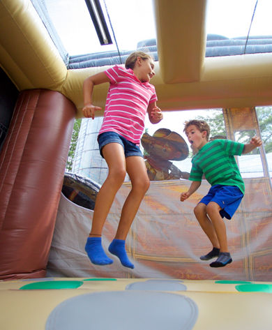 Kids Bouncing in the Okemo Adventure Zone Bouncy House Summer