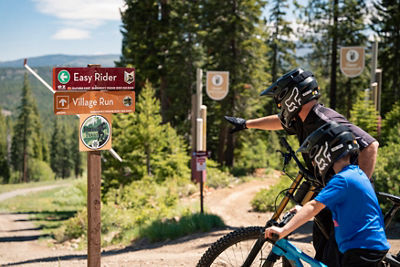Family reads trail signs at Northstar Bike Park