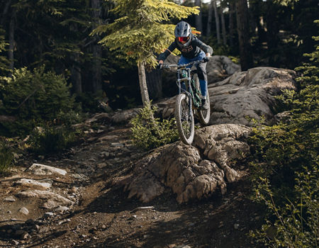 Mountain Biker on rock roll in Whistler Mountain Bike Park