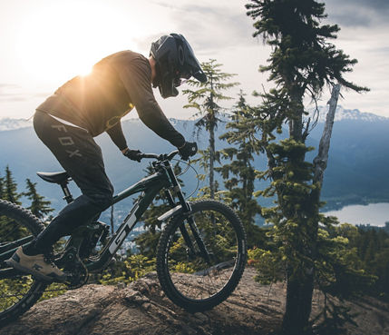 Dropping into a rock roll with a Alpha lake in the background