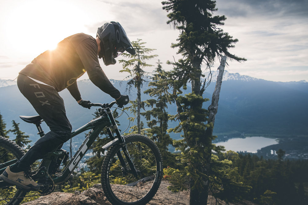 Dropping into a rock roll with a Alpha lake in the background