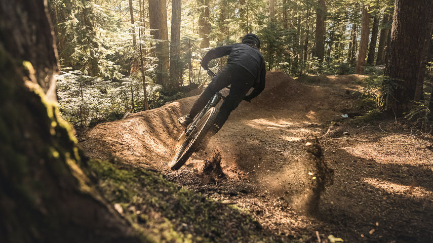 Mountain Biker approaching a berm in Creekside