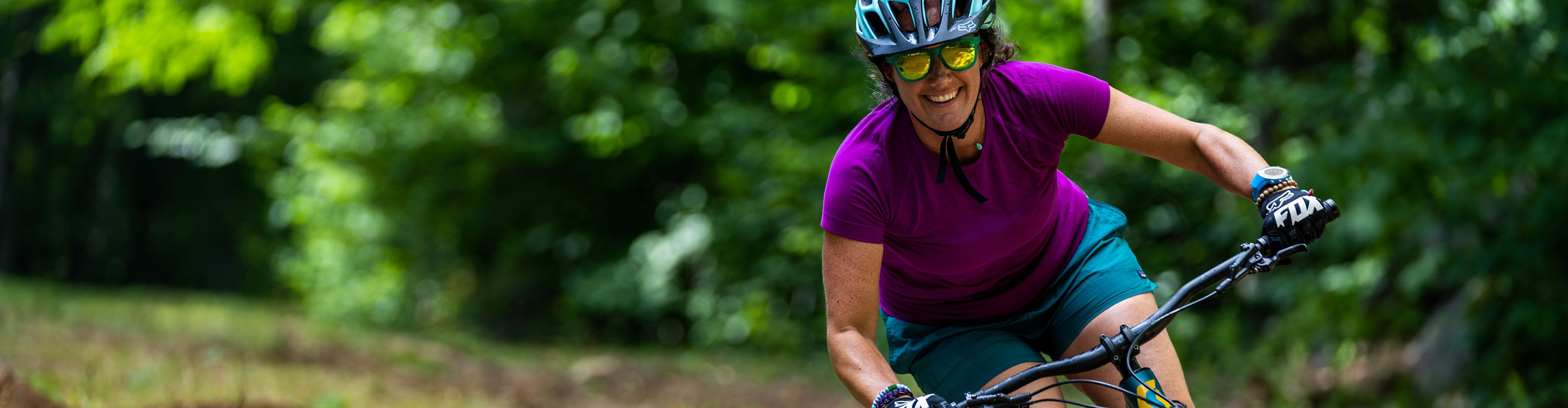 Woman Rides Mountain Bike on Trail at Mount Sunapee