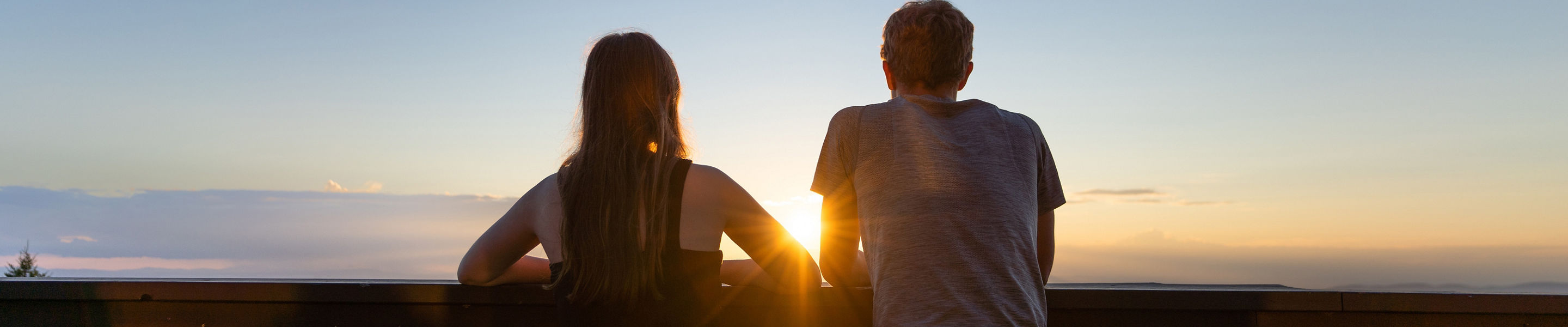 Man and Woman Take In Scenic Landscape Views at Mount Sunapee During Sunset