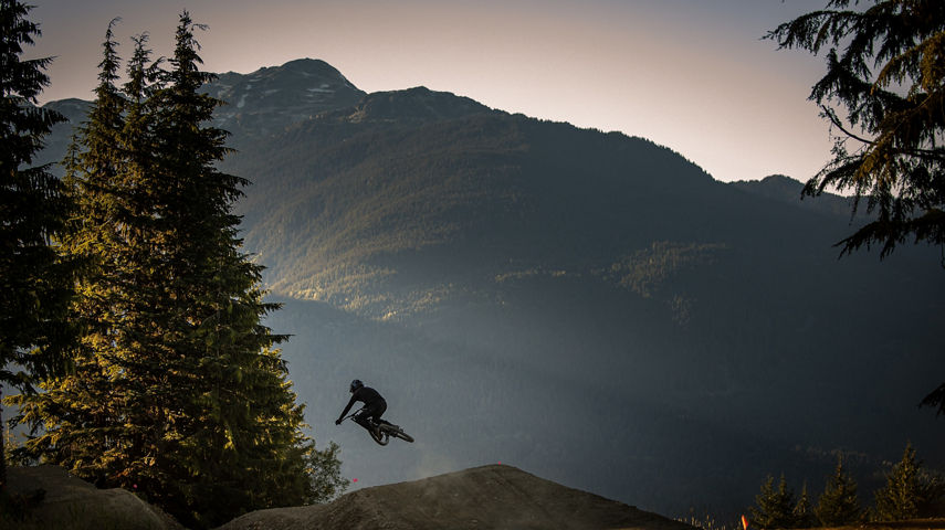 Silhouette of a mountain biker jumping in Whistler 
