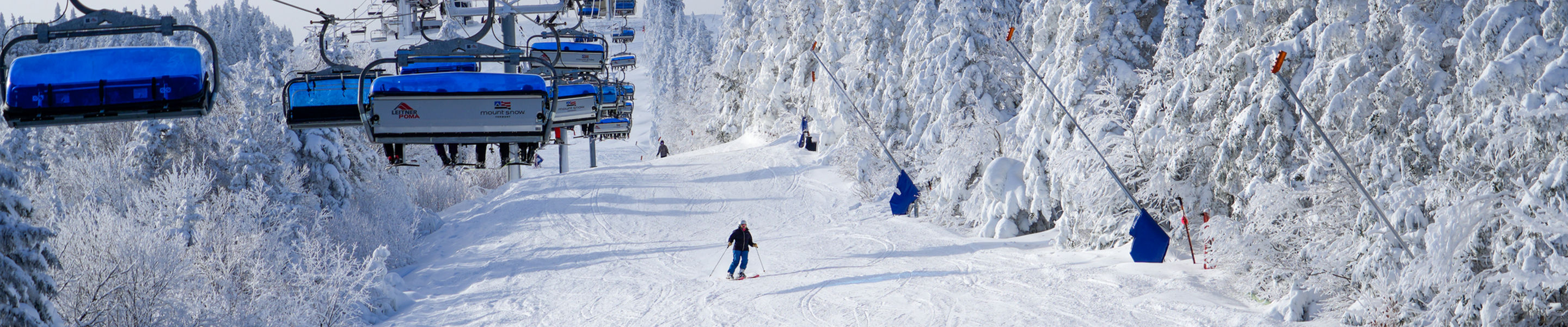 Skiers Descend Snowy Mountain at Mount Snow