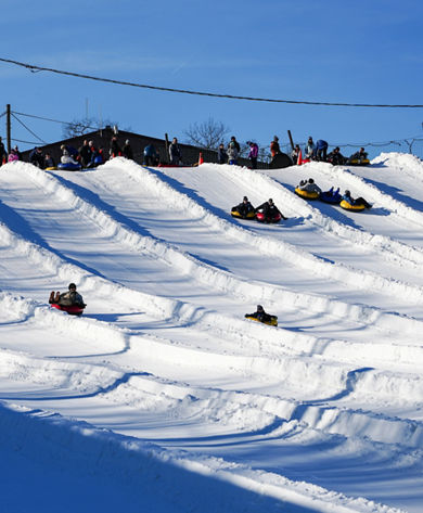 Resort Guests Enjoy Tubing Down Hill at Roundtop