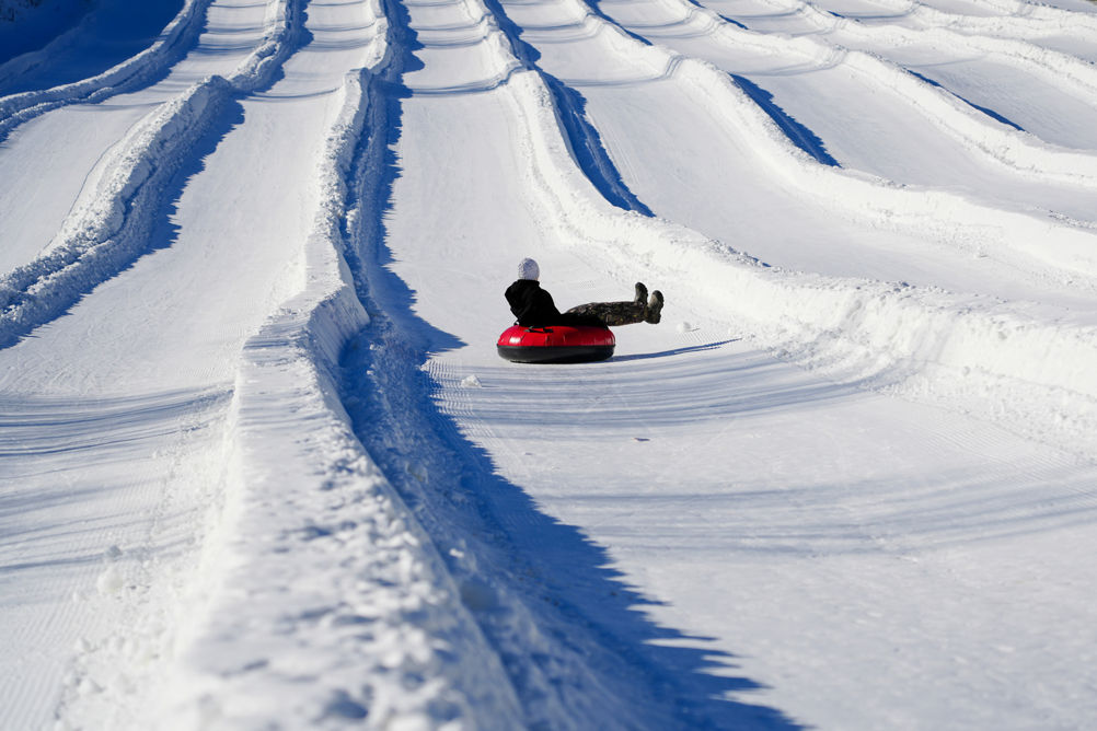 Resort Guests Enjoy Tubing Down Hill at Roundtop
