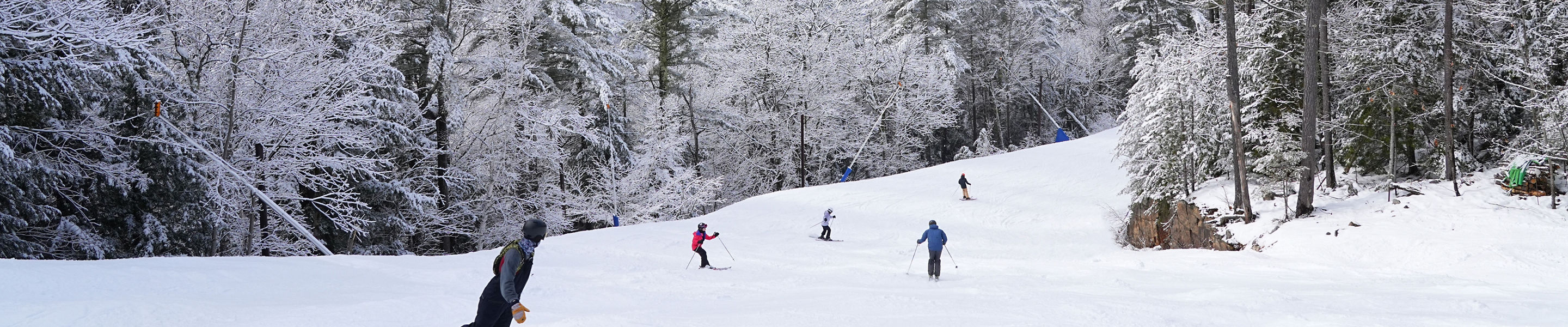 Group of Skiers and Snowboarders Ride in Hazy Winter Weather at Attitash