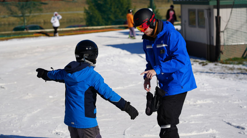 Ski and Ride School Giving Lessons on a Bluebird Day on Fanny Hill at Roundtop