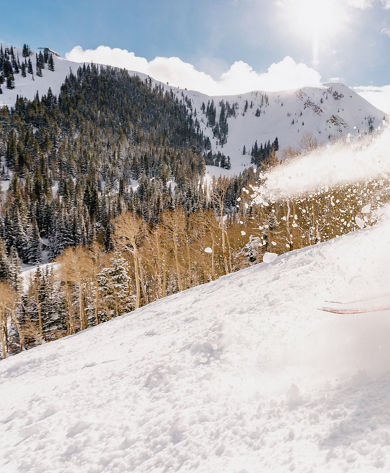 Skier in Yellow Jacket Hitting Fresh Powder at Park City