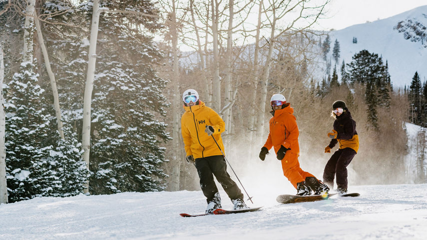 Group of Friends Skiing and Riding Through Fresh Snowfall at Park City