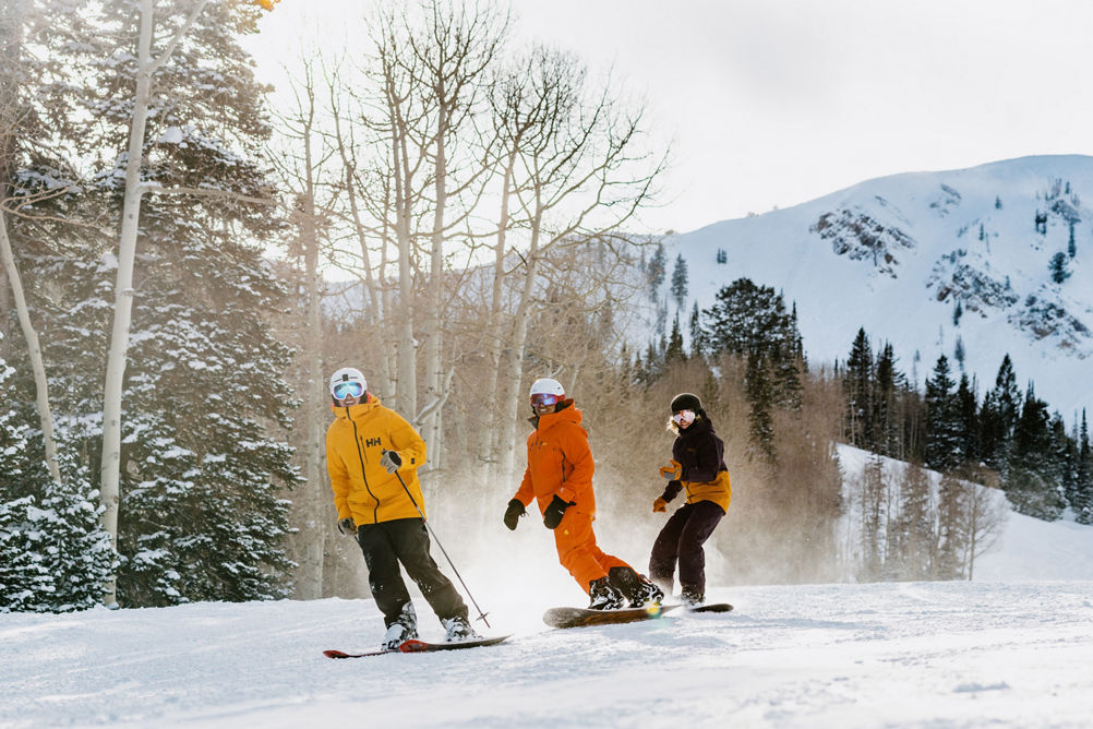 Group of Friends Skiing and Riding Through Fresh Snowfall at Park City