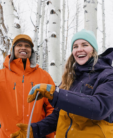 Lifestyle Shot of Two Snowboarders Stand Among Aspen Trees at Park City