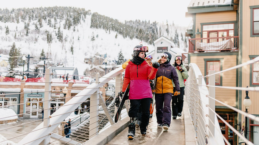 Lifestyle Shot of Friends in Ski Gear Walking Through the Village at Park City