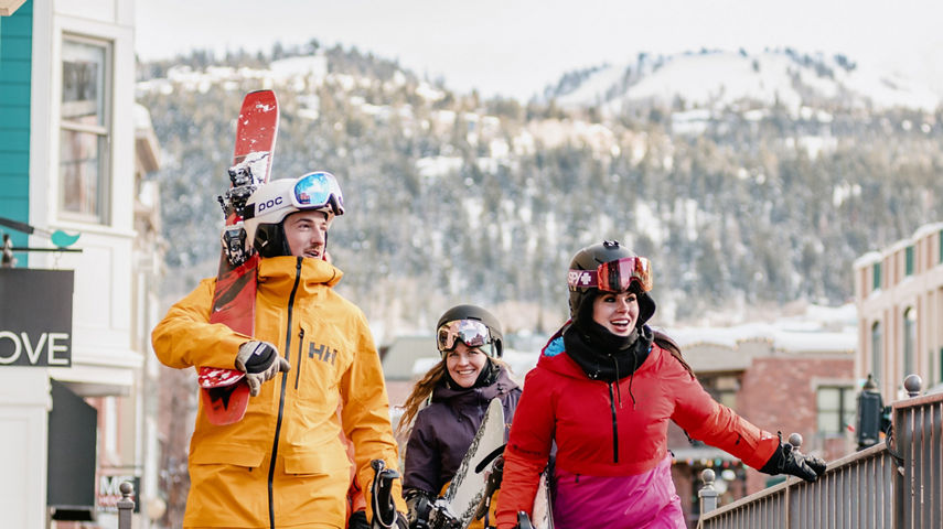 Lifestyle Shot of Friends in Ski Gear Walking Through the Village at Park City