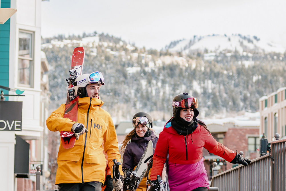 Lifestyle Shot of Friends in Ski Gear Walking Through the Village at Park City