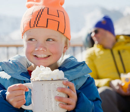 Young Child Enjoys Sipping on Hot Chocoloate